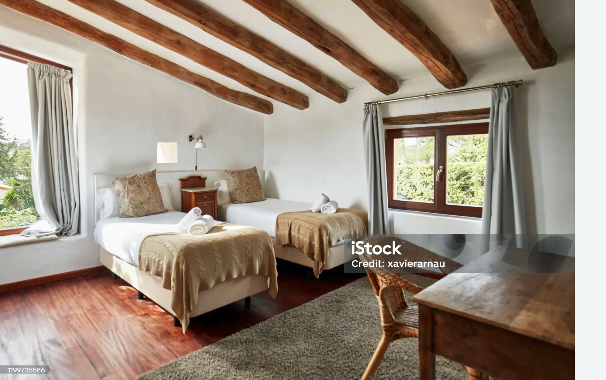 Bedroom with wooden beams and whitewashed walls